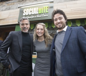 George Clooney with Josh Littlejohn and Alice Thomson, founders of Social Bite, outside the café on Rose Street, Edinburgh.