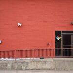 Security camera and rear entrance on a commercial building: Five Warning Signs That Your Business Premises Are an Easy Target