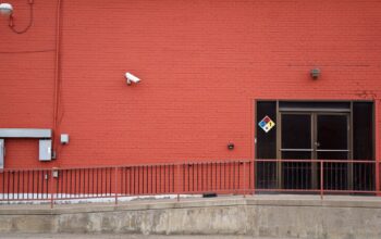 Security camera and rear entrance on a commercial building: Five Warning Signs That Your Business Premises Are an Easy Target