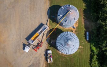 Grain storage bins and auger on a farm