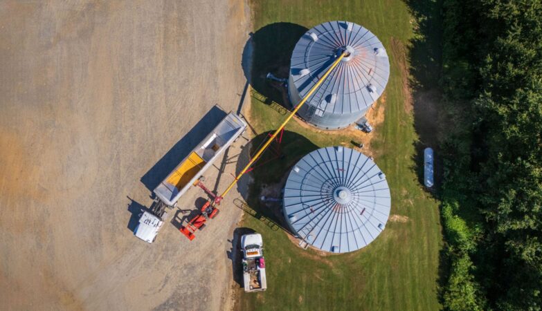 Grain storage bins and auger on a farm