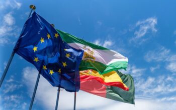 European Union flags flying against a clear blue sky