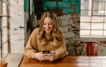 Borrower checking a loan account on a smartphone: Why Lender Support Should Not End When the Money Arrives