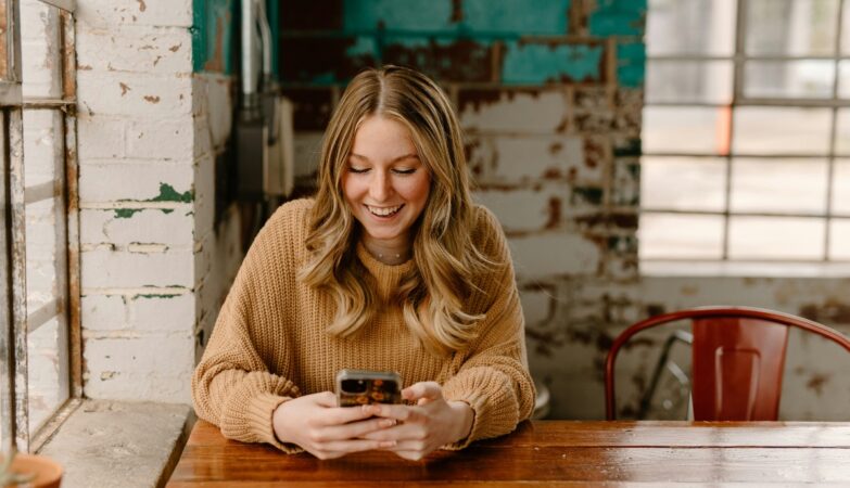 Borrower checking a loan account on a smartphone: Why Lender Support Should Not End When the Money Arrives
