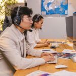 Offshore team members working at computers with headsets