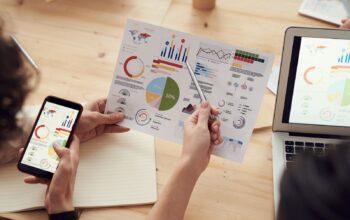 Generalist Agencies Rarely Match the Speed of Industry-Seasoned SEO Teams: marketing specialists reviewing SEO and campaign analytics charts at a desk