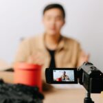 Creator filming a video ad on a camcorder