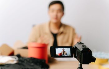 Creator filming a video ad on a camcorder