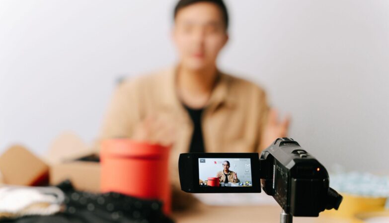 Creator filming a video ad on a camcorder
