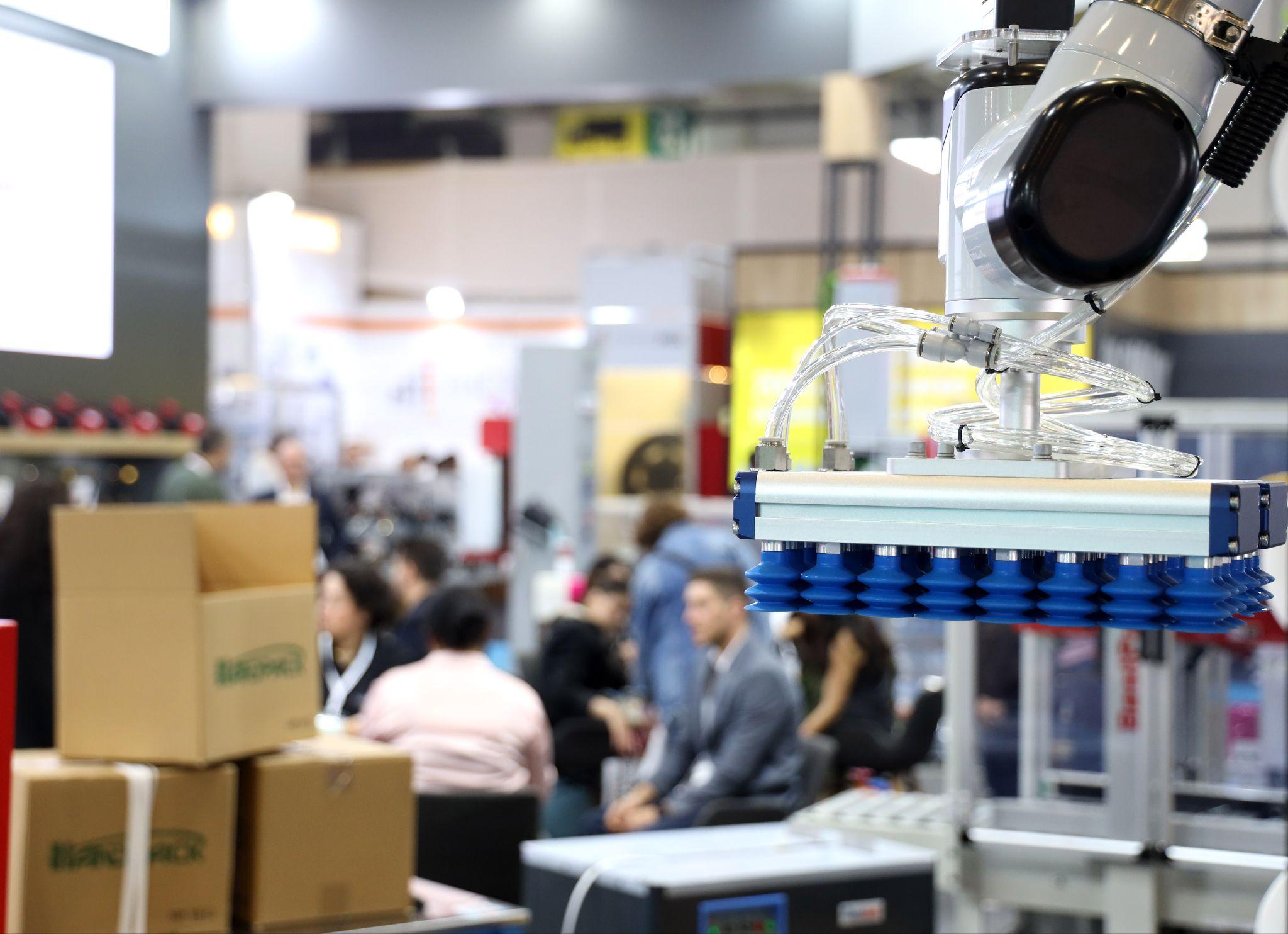 Tüyap Fair and Congress Center welcomes Eurasia Packaging from 13 to 16 October 2026: a robotic vacuum gripper lifting cartons on an exhibitor stand at Eurasia Packaging Istanbul